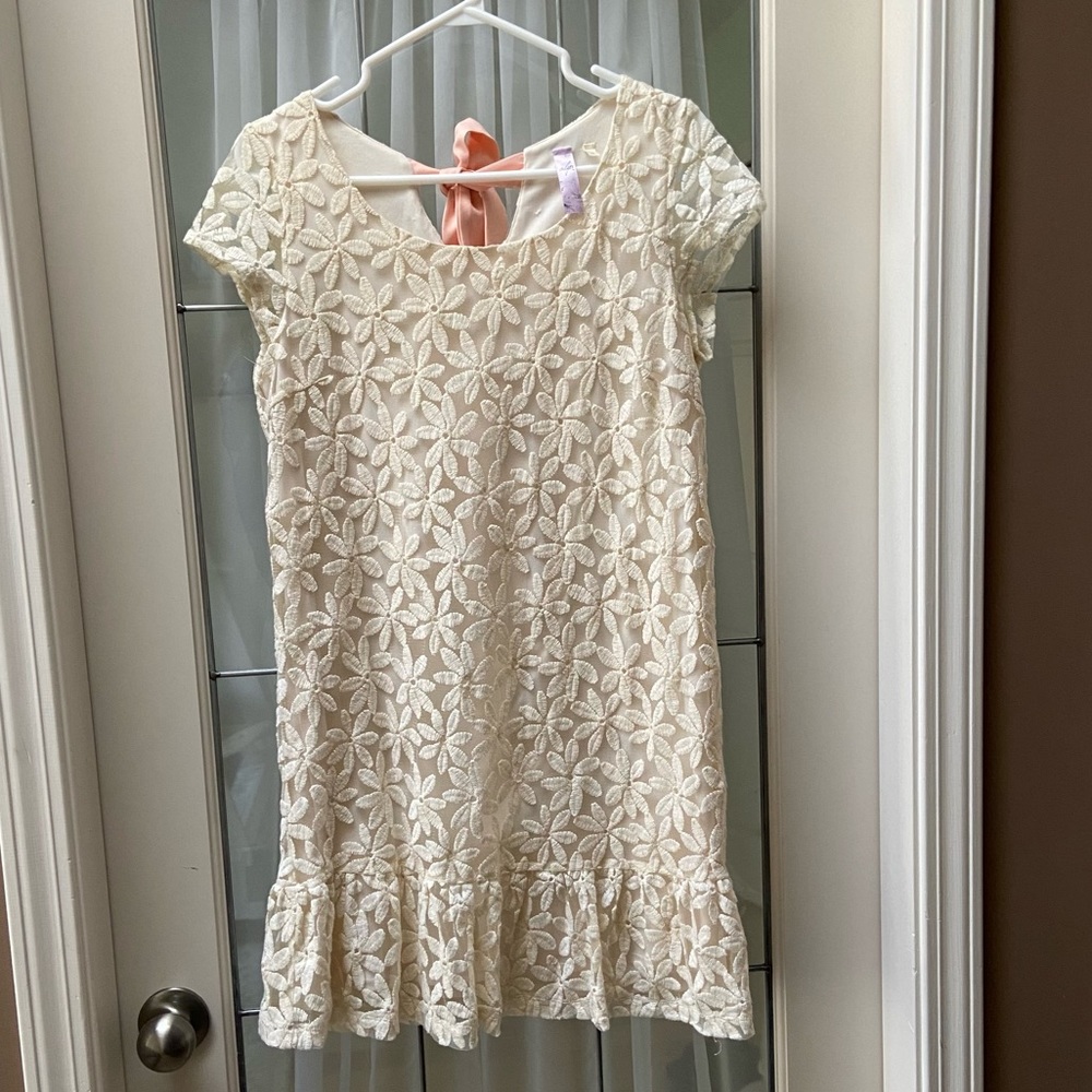 Beautiful and cute lace dress with peach bow on the back.
